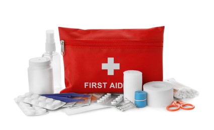 Photo of Red first aid kit, scissors, pins, cotton buds, pills, plastic forceps, medical plasters, hand sanitizer and elastic bandage isolated on white