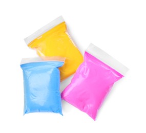 Photo of Packages of different colorful plasticine on white background, top view