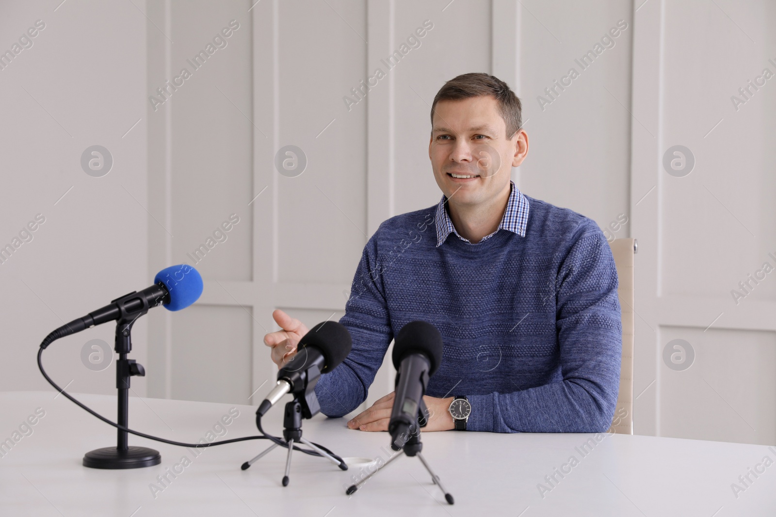Photo of Business man giving interview at official event