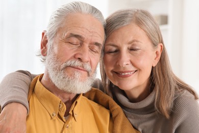 Photo of Portrait of affectionate senior couple at home