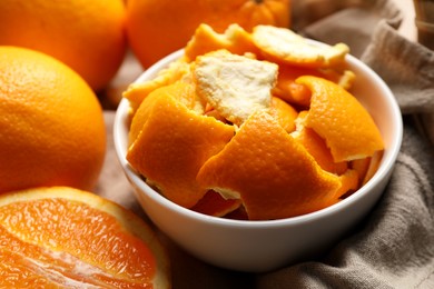 Photo of Orange peels preparing for drying and fresh fruits on table, closeup