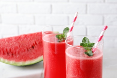 Photo of Tasty summer watermelon drink with mint in glasses, closeup