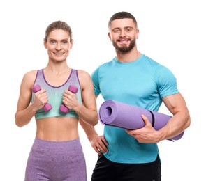 Photo of Athletic people with dumbbells and fitness mat on white background