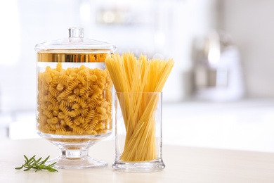 Raw pasta on wooden table in modern kitchen