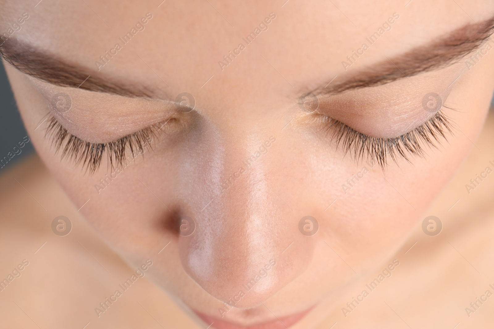 Photo of Young woman with beautiful natural eyelashes, closeup