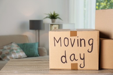 Cardboard boxes on table against blurred background. Moving day