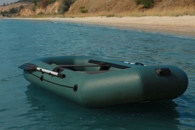 Photo of Inflatable rubber fishing boat floating in sea near coast