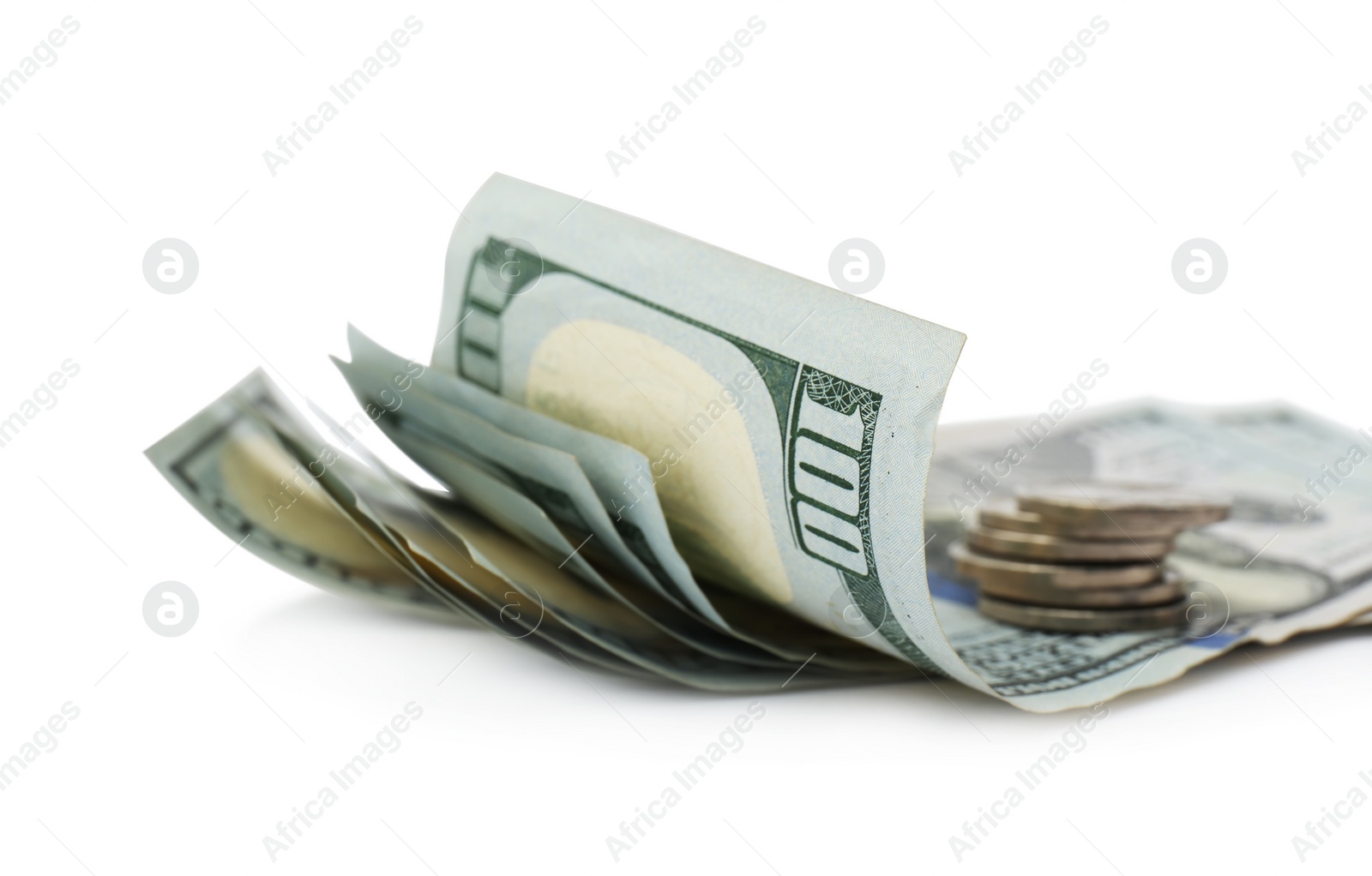Photo of Dollar banknotes and stack of coins on white background, closeup