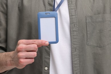 Man in shirt showing empty badge, closeup