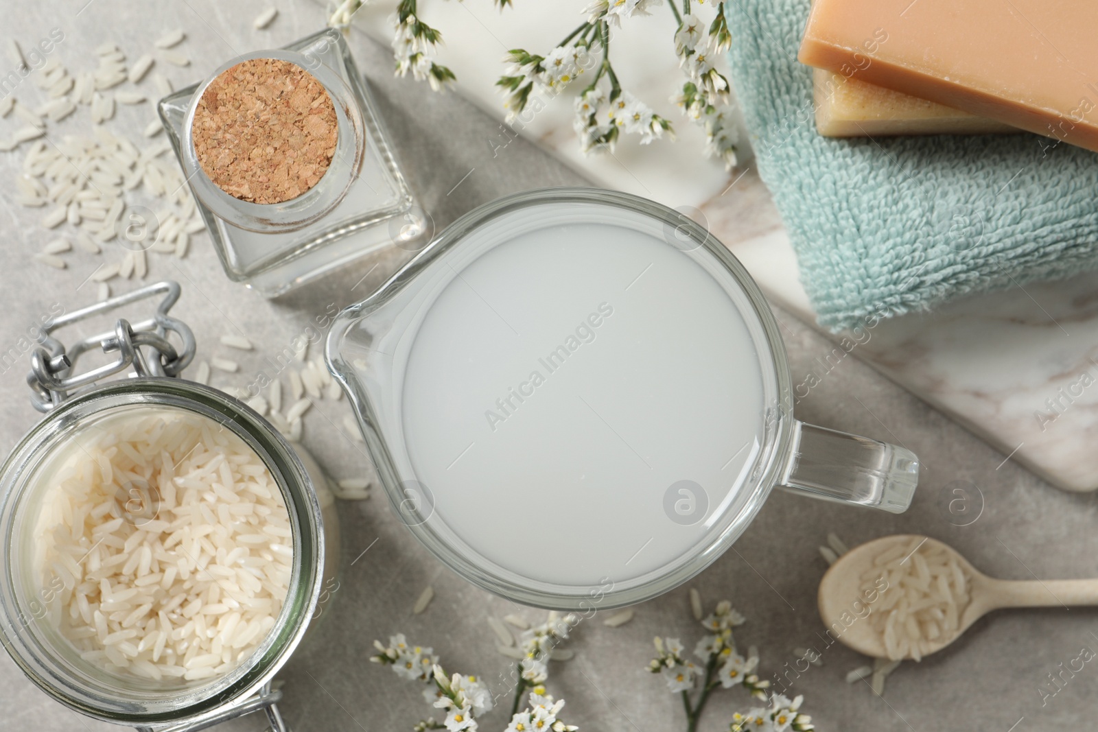 Photo of Flat lay composition with natural rice water on light grey table