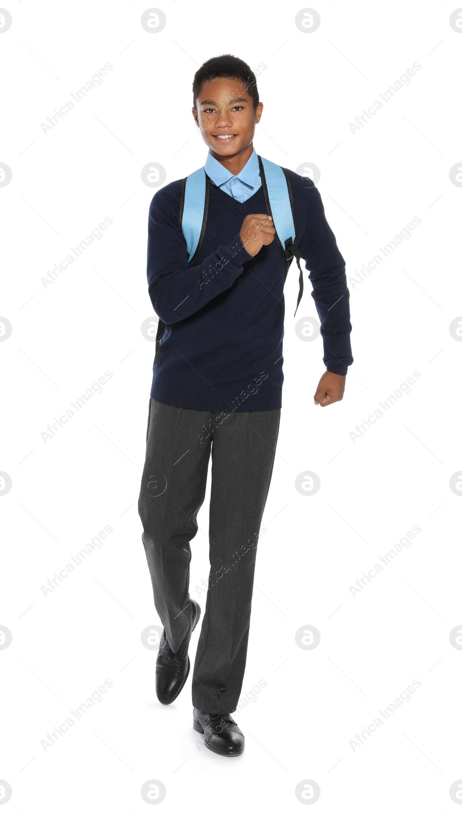 Photo of African American teenage boy in stylish school uniform on white background