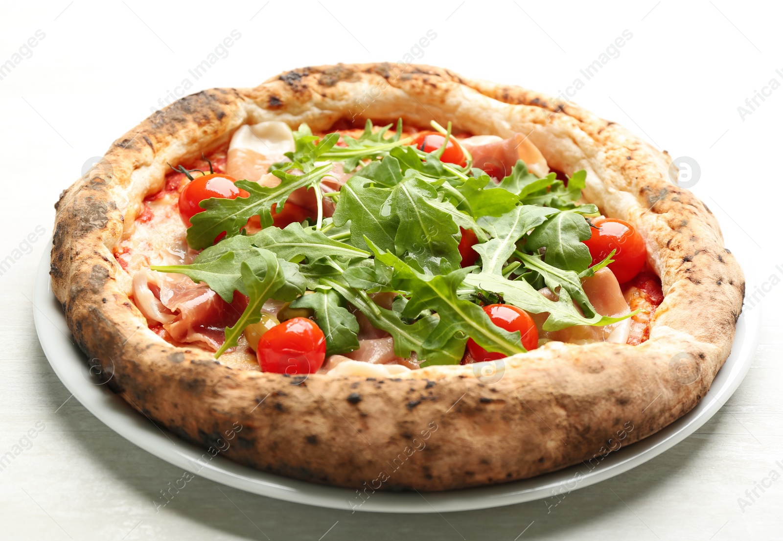 Photo of Tasty pizza with meat and arugula on white table, closeup
