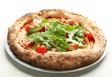 Tasty pizza with meat and arugula on white table, closeup