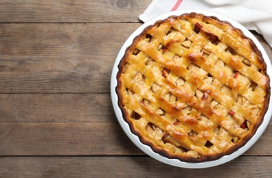 Traditional apple pie on wooden table, top view. Space for text