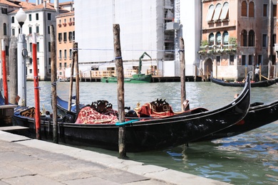 VENICE, ITALY - JUNE 13, 2019: Gondolas moored at pier in city