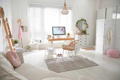 Photo of Stylish home office interior with sofa and comfortable workplace