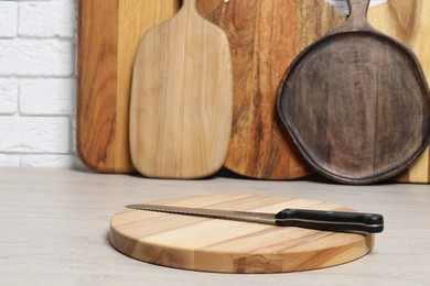 Different cutting boards and knife on light table