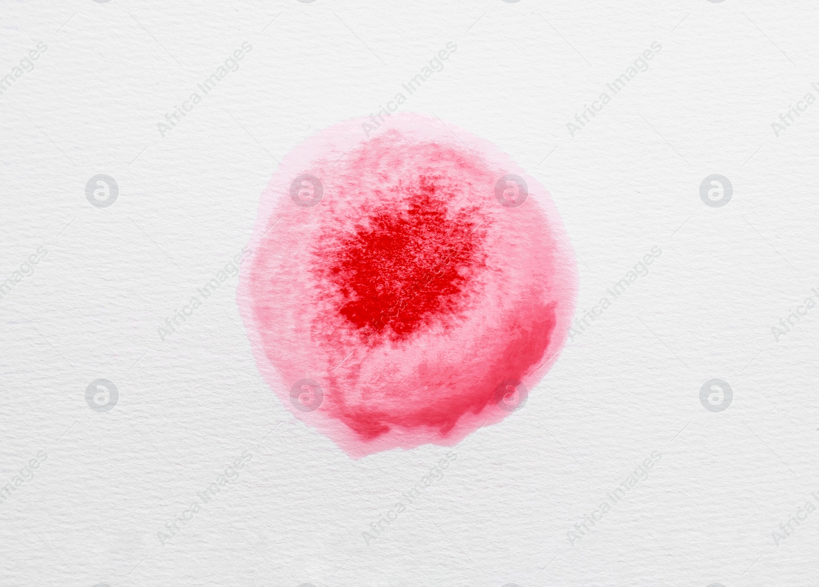 Photo of Blot of pink ink on white background, top view