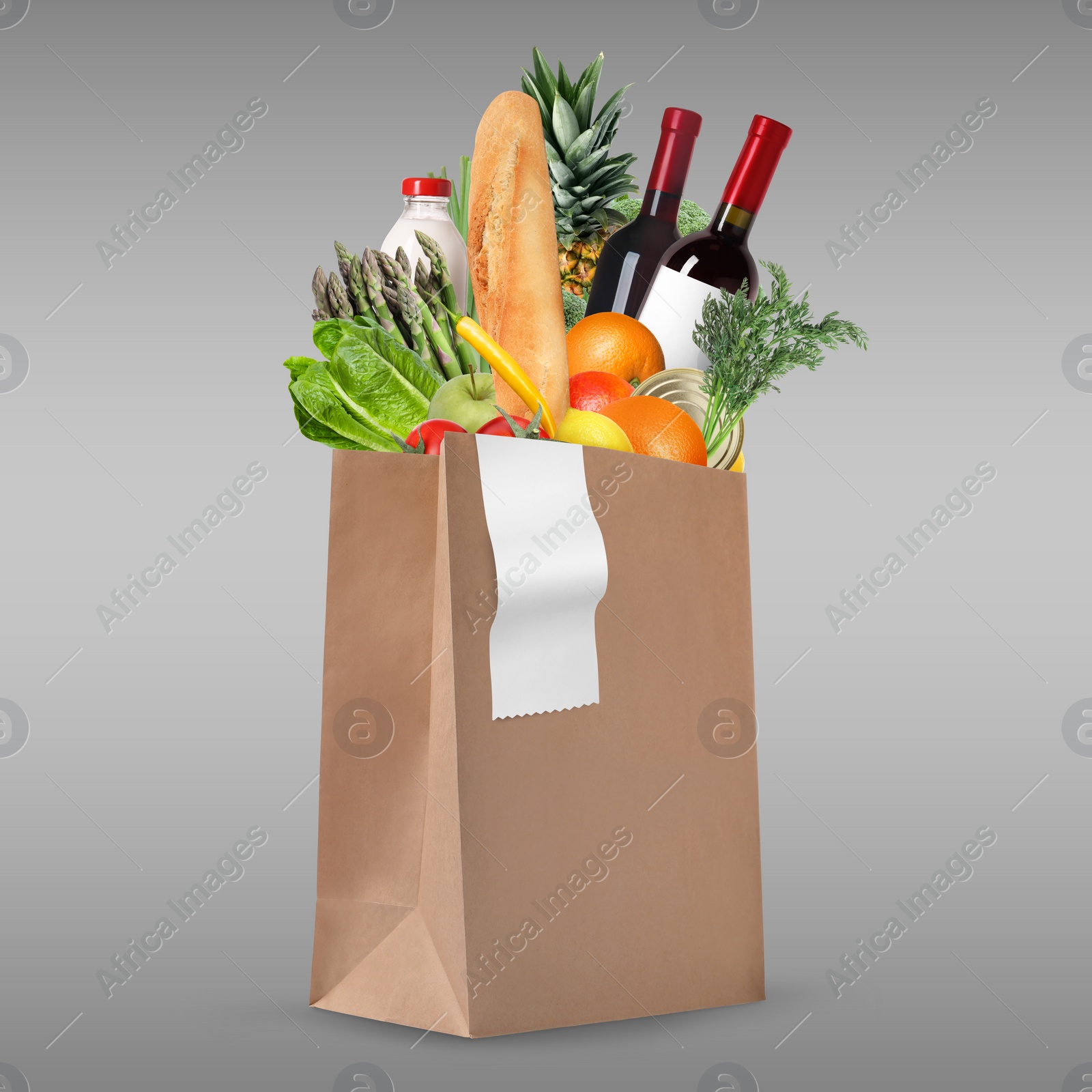 Image of Paper bag with different products and receipt on grey gradient background