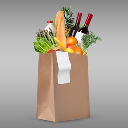 Image of Paper bag with different products and receipt on grey gradient background