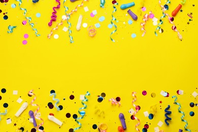 Photo of Flat lay composition with carnival items on yellow background. Space for text