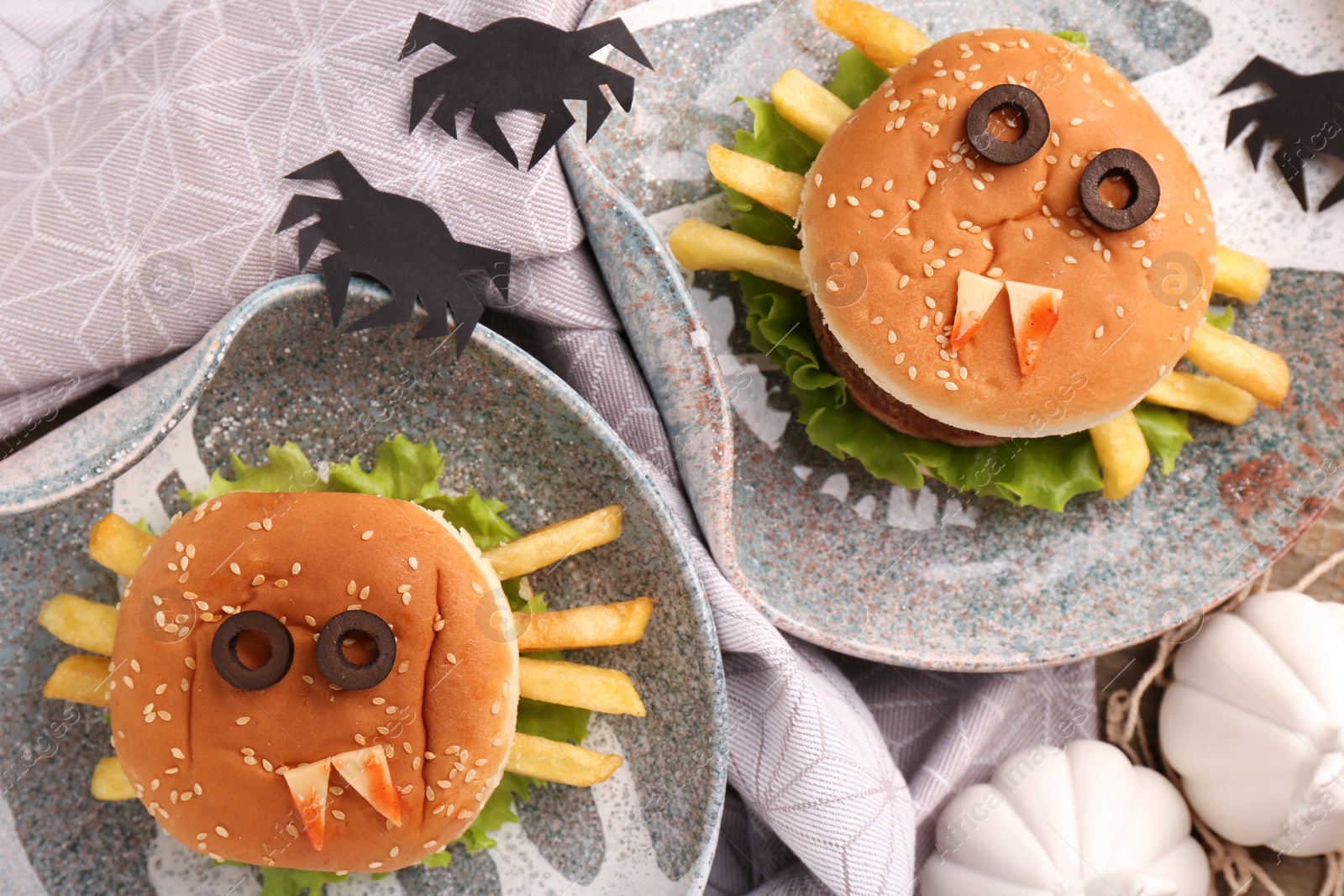 Photo of Flat lay composition with tasty monster sandwiches for Halloween party on table