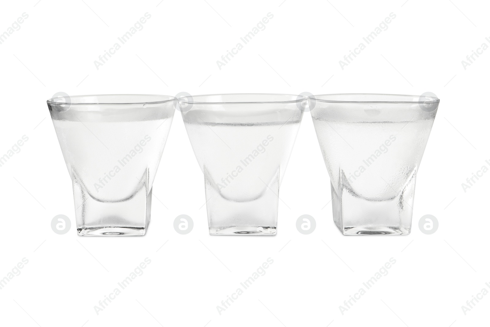 Photo of Vodka in shot glasses on white background