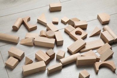 Photo of Wooden building blocks set on floor. Child's toy