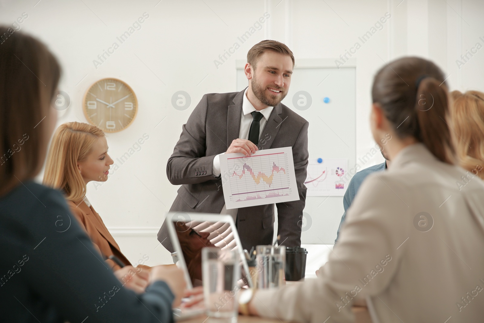 Photo of Businesspeople having meeting in office. Management consulting