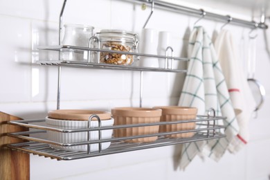 Photo of Many different ramekins on metal rack in kitchen