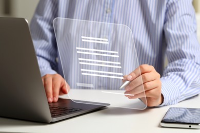 Woman signing electronic document via virtual screen over laptop at table, closeup