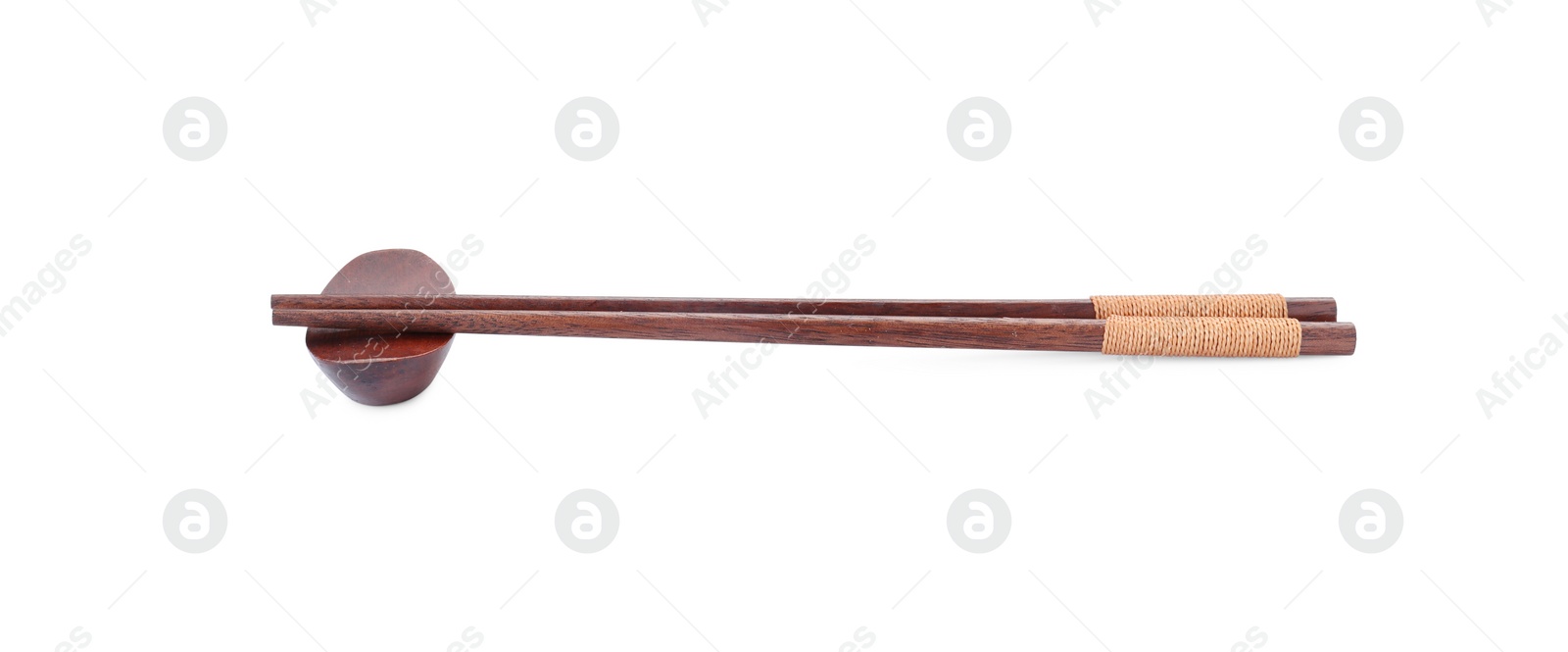 Photo of Pair of wooden chopsticks with rest isolated on white