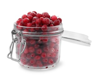 Photo of Frozen red cranberries in glass jar isolated on white