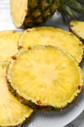 Photo of Slices of tasty ripe pineapple on table, closeup