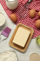 Photo of Flat lay composition with fresh butter and other products on light wooden table