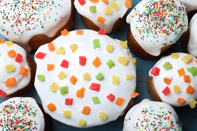 Traditional Easter cakes on blue wooden table, flat lay