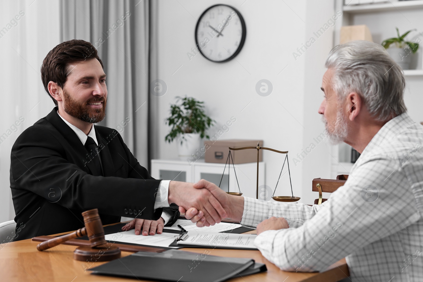 Photo of Lawyer shaking hands with client in office