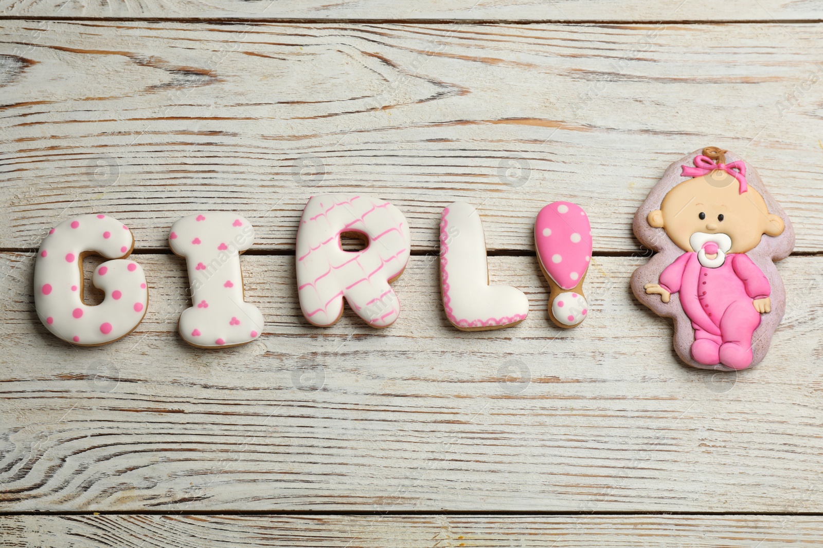 Photo of Word Girl made of tasty cookies on white wooden table, flat lay. Baby shower party