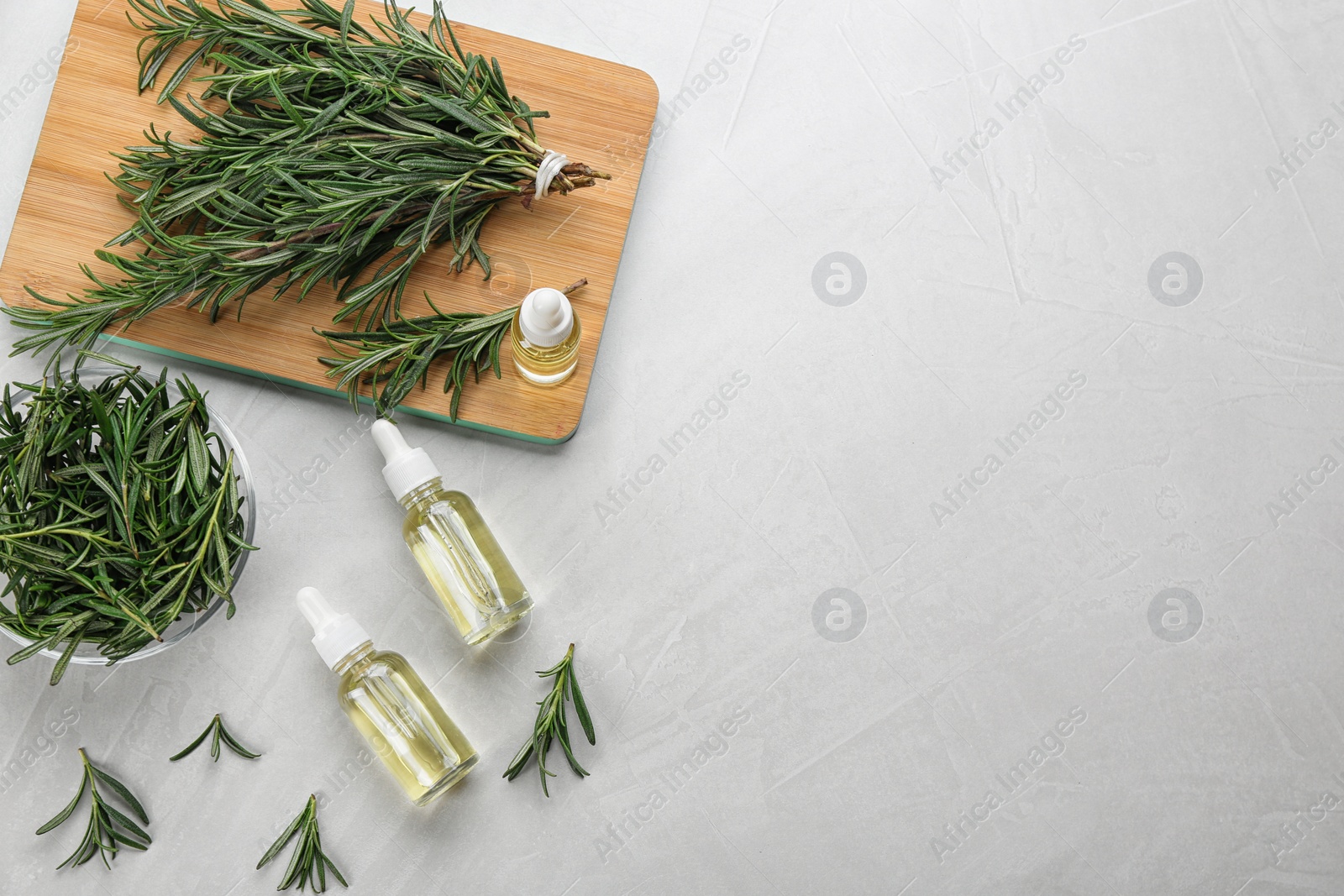 Photo of Flat lay composition with fresh rosemary on light table. Space for text