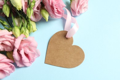 Photo of Happy Mother's Day. Beautiful flowers with blank heart shaped card on light blue background, flat lay