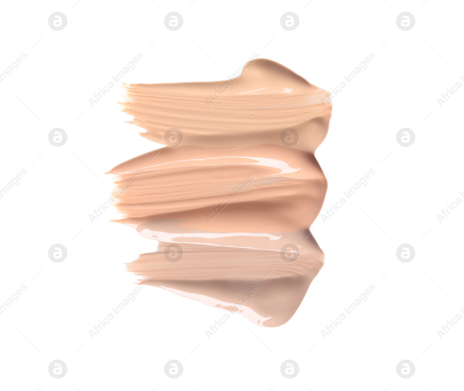 Photo of Samples of different foundation shades on white background, top view