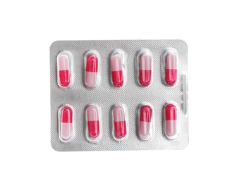 Pills in blister pack on white background, top view