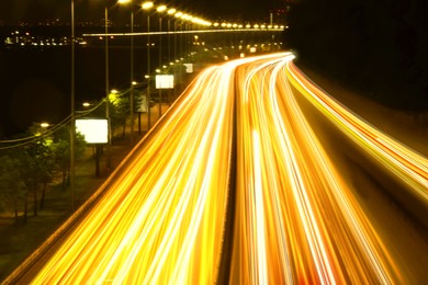 Image of Road traffic, motion blur effect. View of car light trails at night