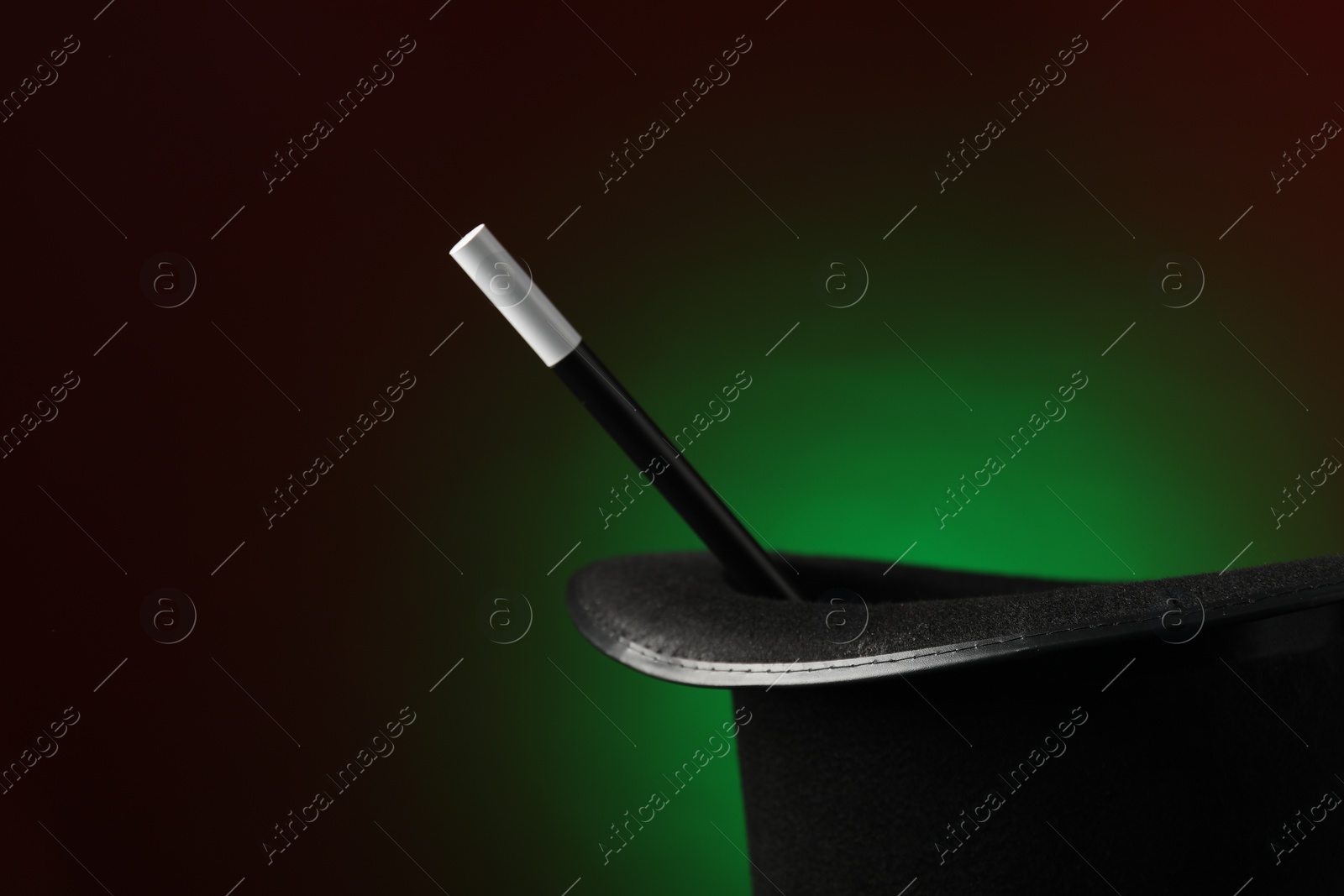 Photo of Magician's hat and wand on dark background, space for text