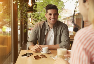 Lovely couple spending time at cafe in morning