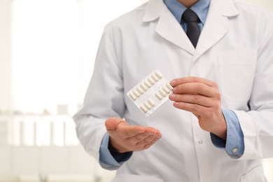 Professional pharmacist with pills in drugstore, closeup