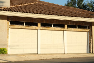 Garage building with closed white sectional gates