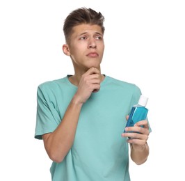 Thoughtful young man with mouthwash on white background