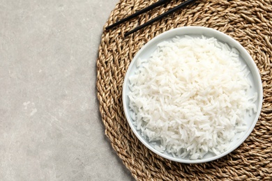 Plate of tasty cooked rice on table, flat lay. Space for text