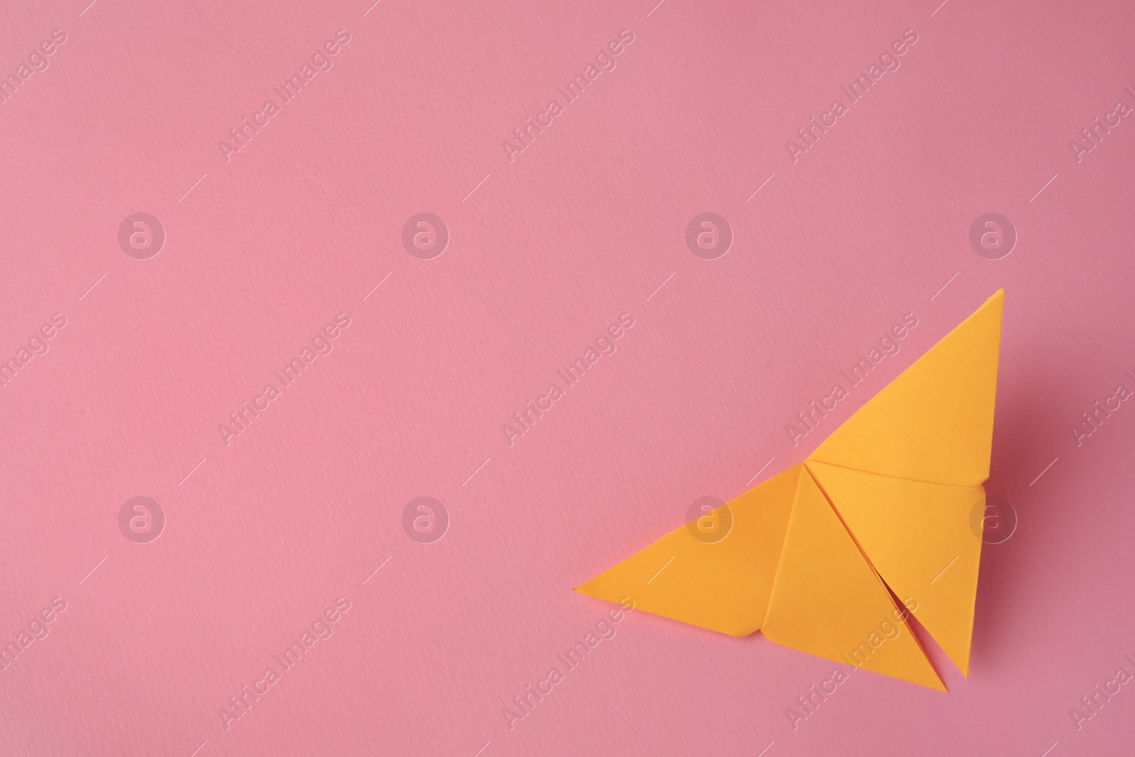 Photo of Origami art. Paper butterfly on pink background, top view. Space for text